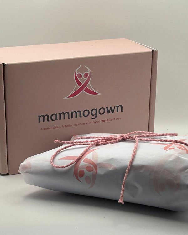 Branded MammoGown box with a folded wrap tied in custom tissue paper and string.